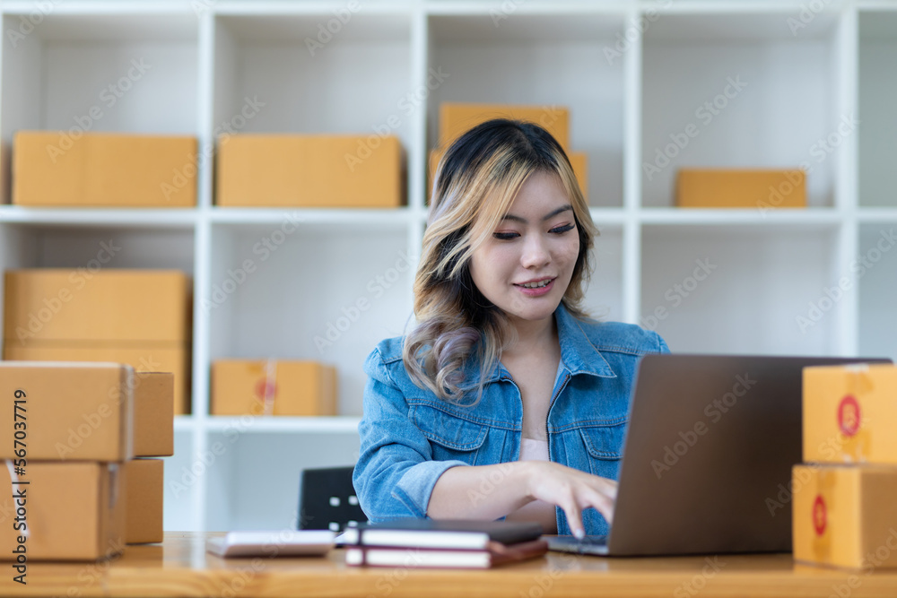 Startup SME small business entrepreneur of freelance Asian woman using laptop and box to receive and review orders online to prepare to pack sell to customers, online sme business ideas. Startup SME small business entrepreneur of freelance Asian woman using laptop and box to receive and review orders online to prepare to pack sell to customers, online sme business ideas.
