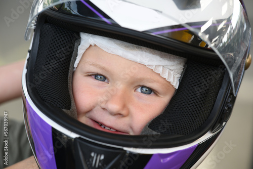 young child with a motorcycle helmet
