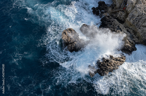 Drone aerial of rocky coast and stormy waves. Seascape windy waves. Stormy sea. Nature background. Cape Greko Cyprus