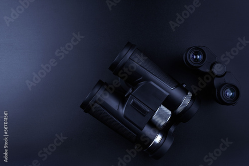 New binoculars isolated on black background. Flat lay, top view