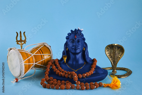 Shivaratri background with Shivas trident, Pellet Drum Damroo musical instrument ans snake . Maha Shivratri festval photo