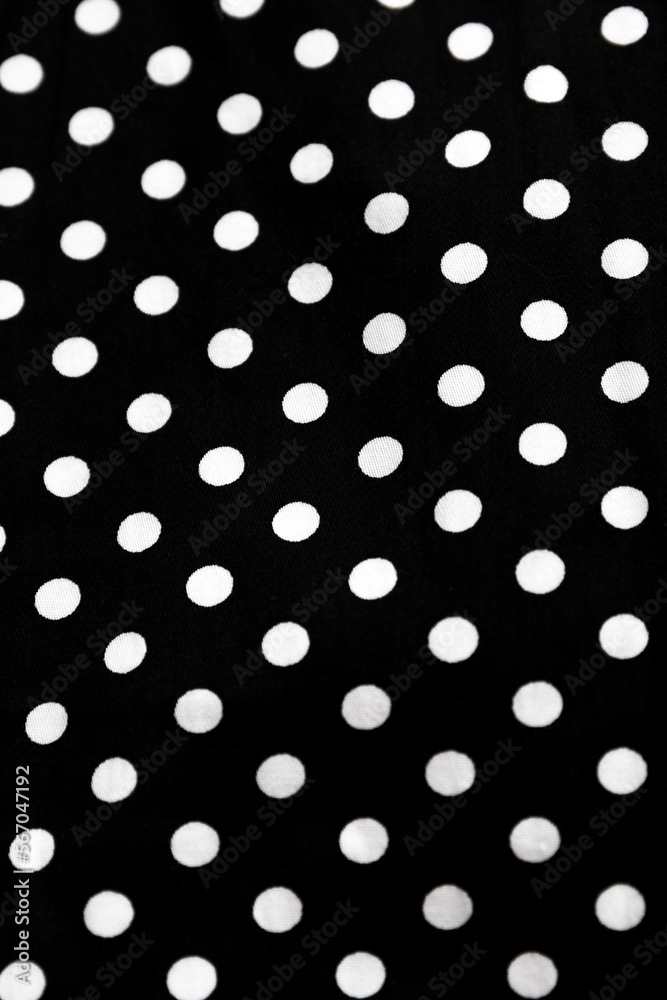 Polka dot patterned black and white fabric textile folded cloths as background Polka dot patterned black and white fabric textile folded cloths as background