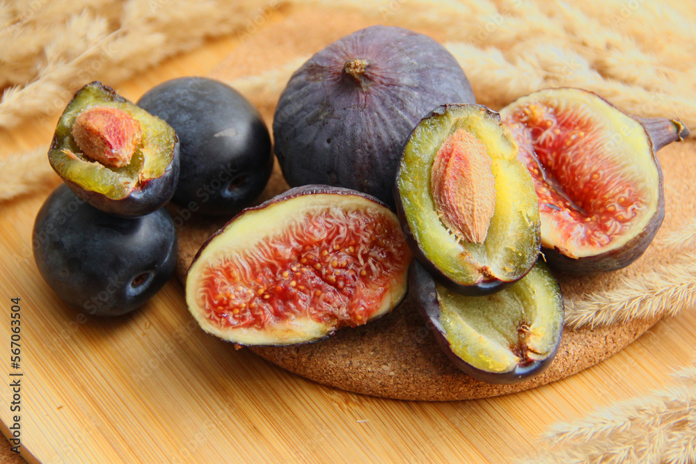 fresh figs and plum on a wooden table fresh figs and plum on a wooden table