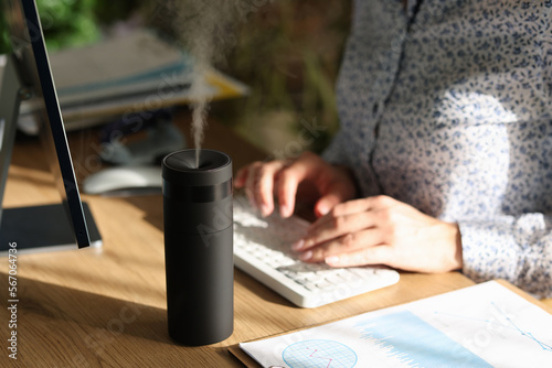 Tableau sur toile Electronic air humidifier on the desk of an office employee