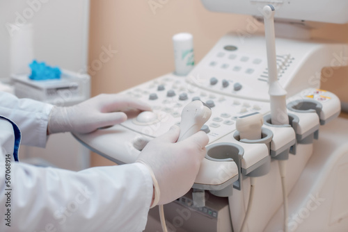 Probe for ultrasound diagnostics close-up. The doctor holds in his hands a transducer with a gel for ultrasound diagnostics of internal organs. Modern ultrasonic machine. Elastography and sonography.