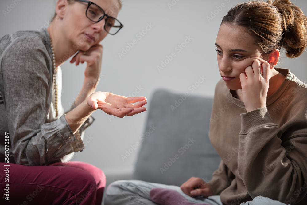Mother talking with difficult teenager daughter at home. Mother talking with difficult teenager daughter at home.