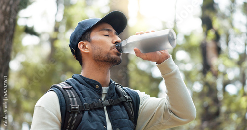 Bilde på lerret Water, drink and man with fitness hiking, exercise and thirsty in forest, nature and woods