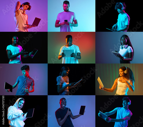 Young motivated emotional women and man demostrate tablet screen, using gadget over light and dark neon backgrounds. Job, education, communication, youth concept photo