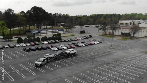 Get an aerial view of a pickup truck towing a carhauler in this review and inspection video. Watch as the semi truck makes a pitstop at a gas station, showcasing its capabilities on the road photo