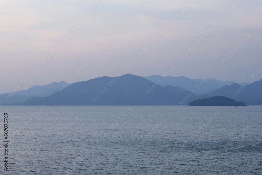 Mountain range and beautiful sky of Kaeng Krachan reservoir, located in central of Thailand, mountain and sky background, morning scene