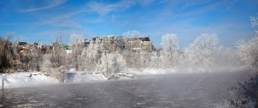 Sherbrooke Quebec Canada, winter landscape cold temperature frozen river mist and fog ice water panorama