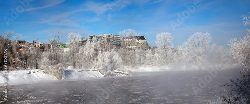 Sherbrooke Quebec Canada, winter landscape cold temperature frozen river mist and fog ice water panorama © Jacques Durocher