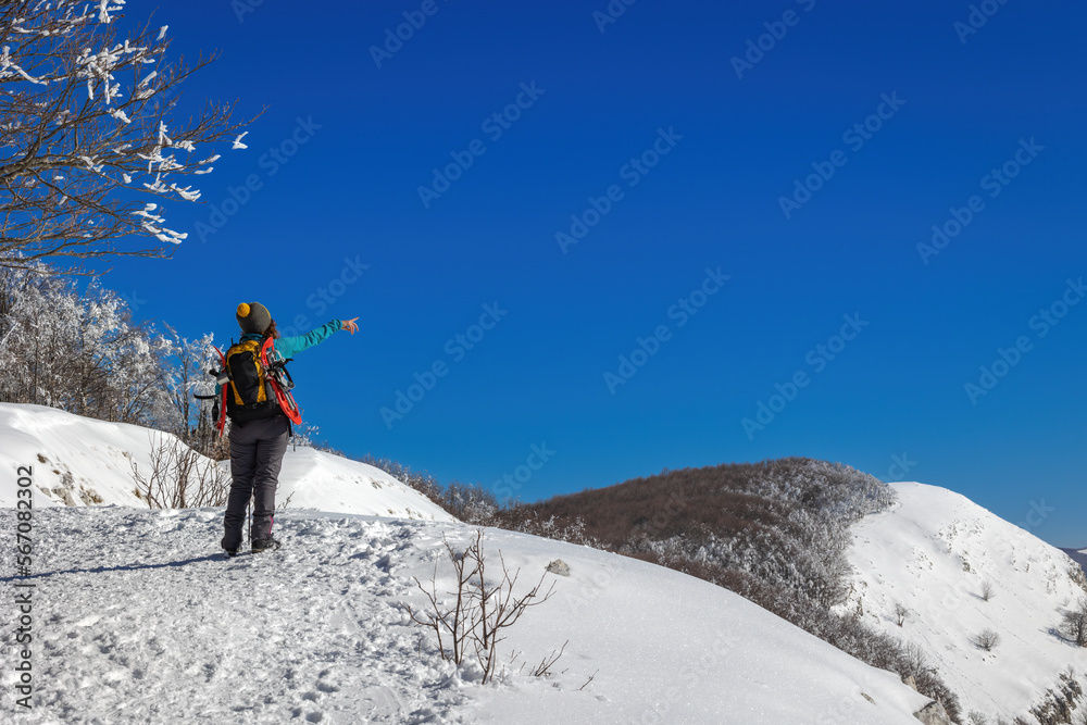 Snow hiker in the mountains, middle aged woman