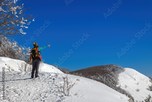 Snow hiker in the mountains, middle aged woman
