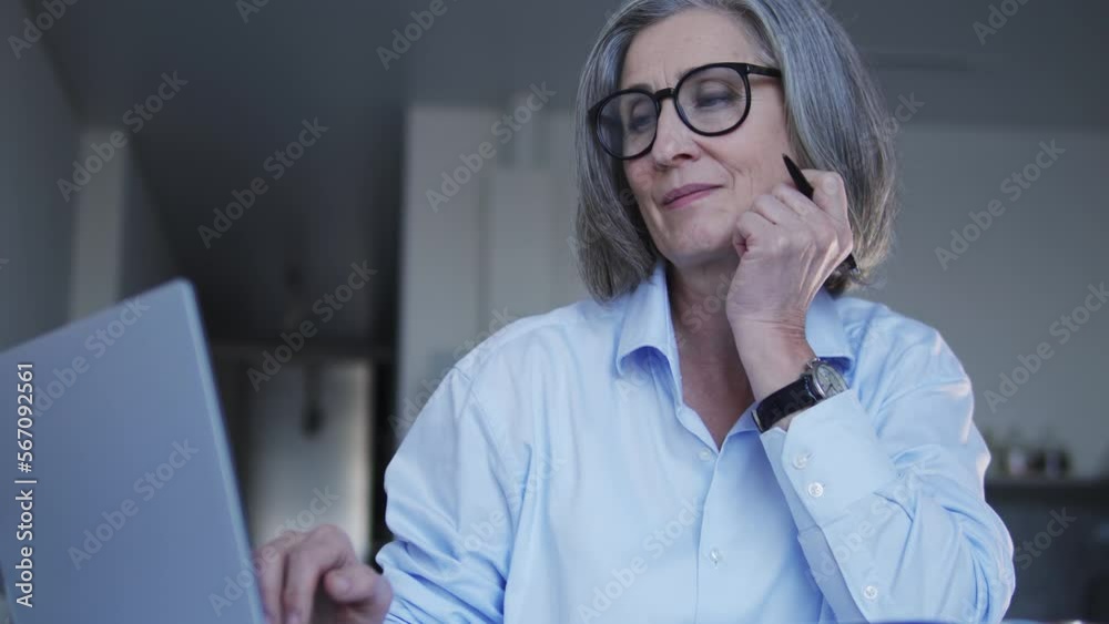 Woman web developer working on project, chatting with client, making notes Woman web developer working on project, chatting with client, making notes