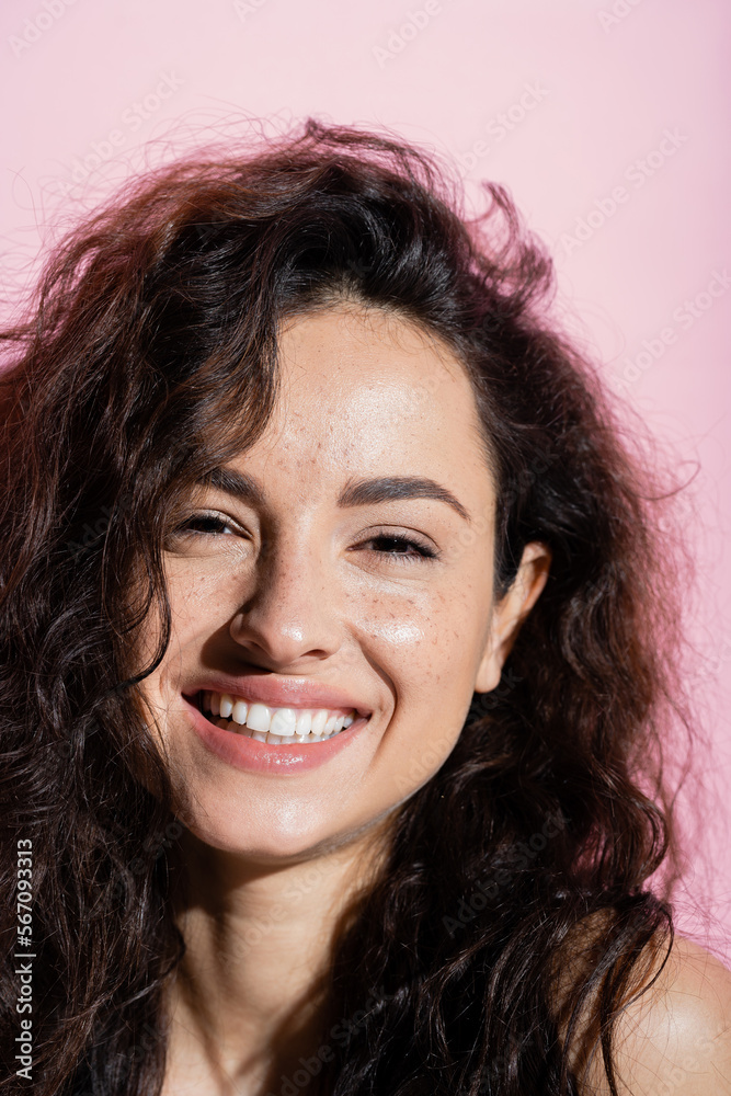 Young freckled woman smiling at camera isolated on pink. Young freckled woman smiling at camera isolated on pink.