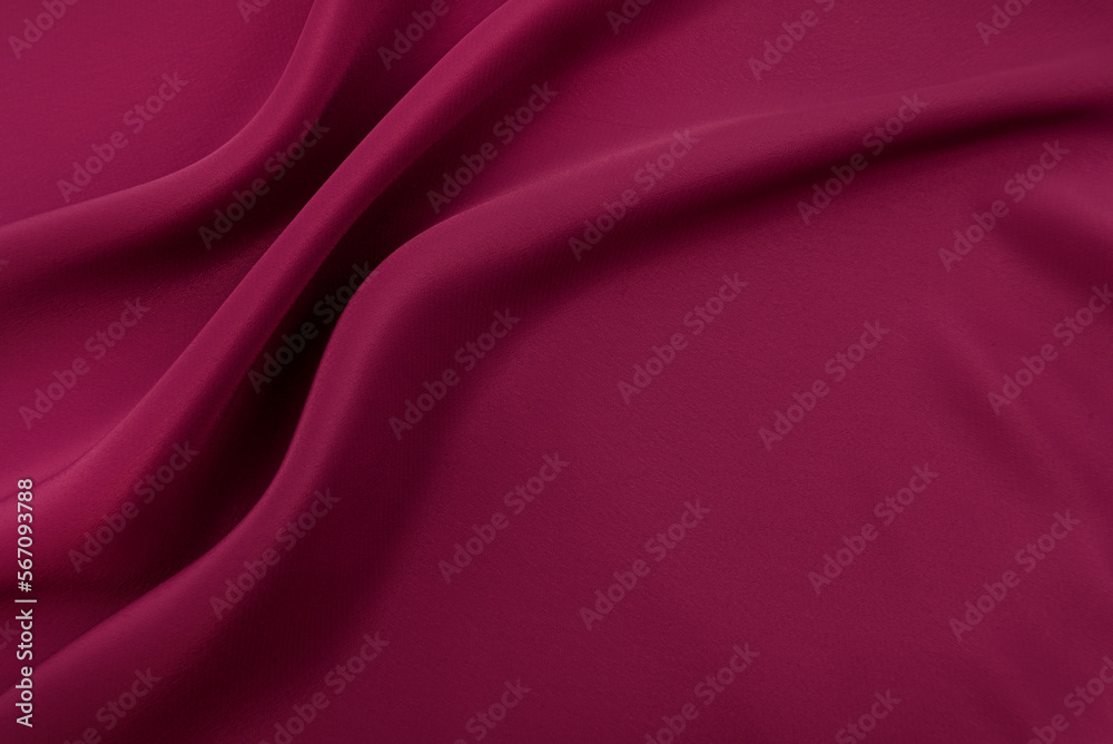 Obraz premium Texture of a smooth luxurious, elegant fabric in burgundy, purple, red. Purple satin or silk fabric with folds and waves
