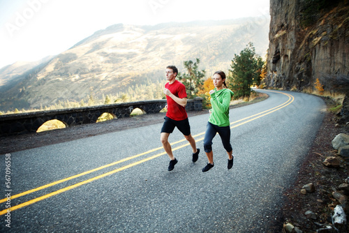 Two runners in their mid 20s running along scenic road in Rowena photo