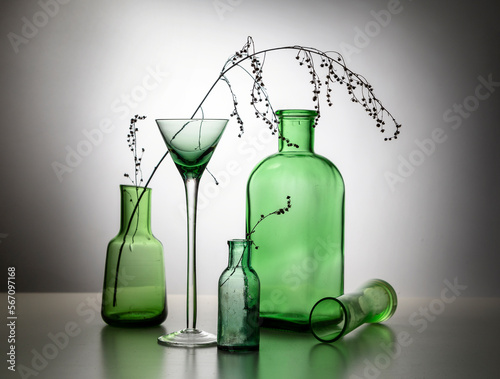 Modern still life with glass bottles and dry branches
