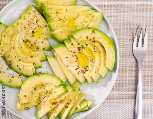 ripe avocado pulp cut into pieces sprinkled with lemon juice on a plate