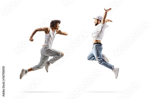 Full length profile shot of a caucasian and an african american male dancer jumping