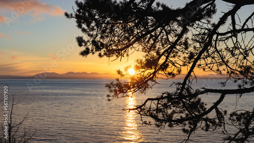 approaching sunset on the Strait of Georgia or Salish Sea looking to Vancouver Island from Lighthouse Park in West Vancouver travel and tourism © Paul Van Buekenhout