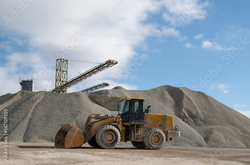 Belt conveyors, piles of rubble and Wheel loader in Gravel Quarry.