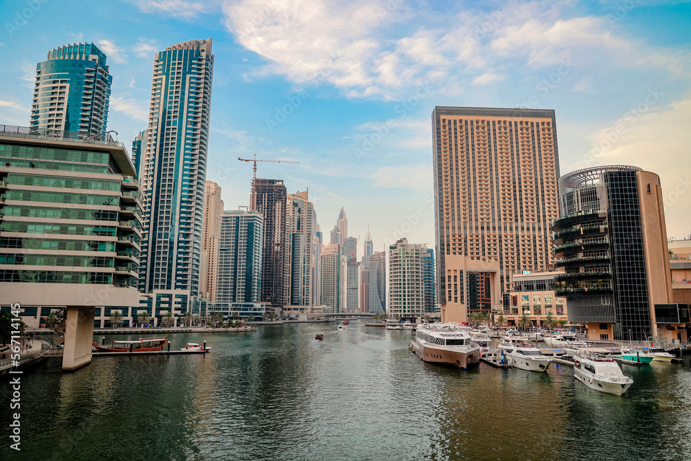 Obraz premium Luxury Dubai Marina skyscrapers, cruise boat , Dubai, United Arab Emirates