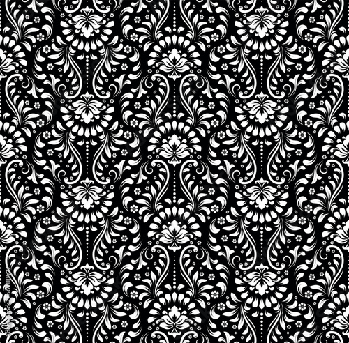 Wallpaper in the style of Baroque. Seamless vector background. White and black floral ornament. Graphic pattern for fabric, wallpaper, packaging. Ornate Damask flower ornament