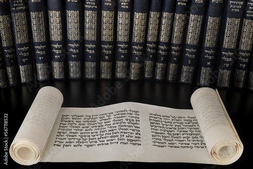 Megillat Esther (Book of Esther) isolated scroll on black backround and talmud. Read on the Jewish holiday of Purim. photo