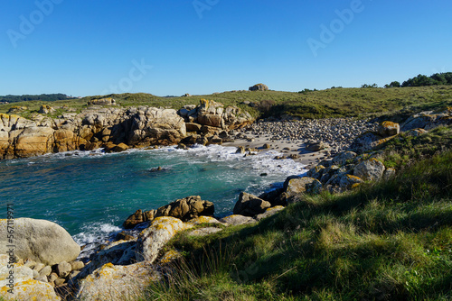 Small cove with large boulders near the Porto de Abaixo fort. Ribeira, Galicia, Spain.