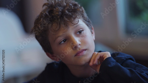 Pensive young boy portrait contemplative child face closeup