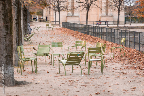 Green chairs of the Tuileries garden in Paris, France in Autumn
