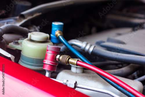 Servicing car air conditioner in vehicle service or repair workshop