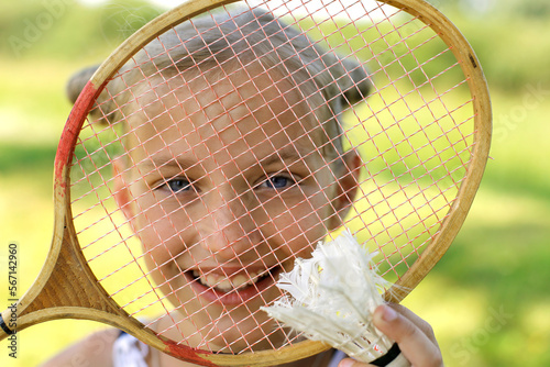 European girl with blue eyes with a badminton racket smiling. Active rest in summer. Summer vacation concept © Вера Шестопалова