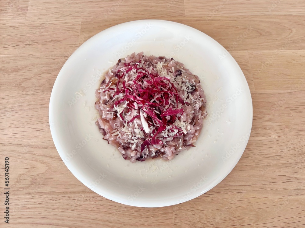 Red chicory risotto on white plate.