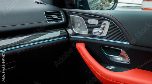 door of an expensive car with red-black leather and ambient lighting with a premium audio system © AvokadoStudio
