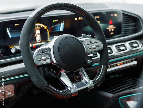 stylish sports steering wheel with alcantara in a premium fast car © AvokadoStudio