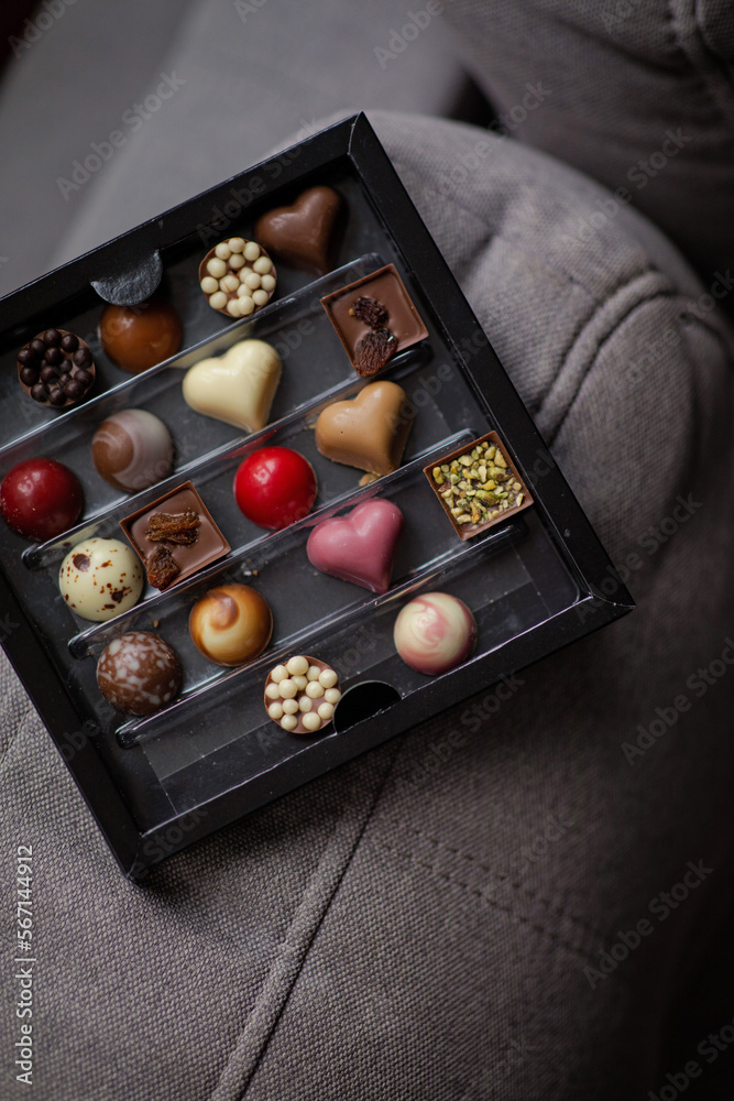 Assorted Valentine’s Day chocolates. Chocolate chocolates in different colors. Heart shaped chocolates. Candy box with sweets