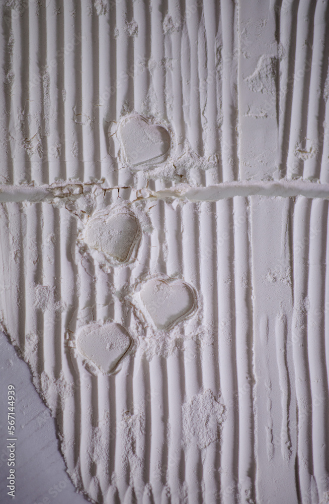 Valentine’s Day. Creative expression. Traces in the shape of a heart white. Lines and shadows. Valentine’s Day card. Heart in white flour