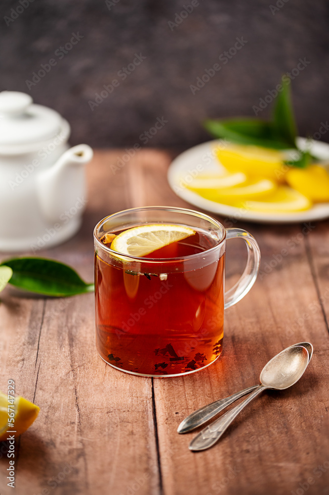 Glass cup of black tea, on wooden table. Hot beverage. Glass cup of black tea, on wooden table. Hot beverage.
