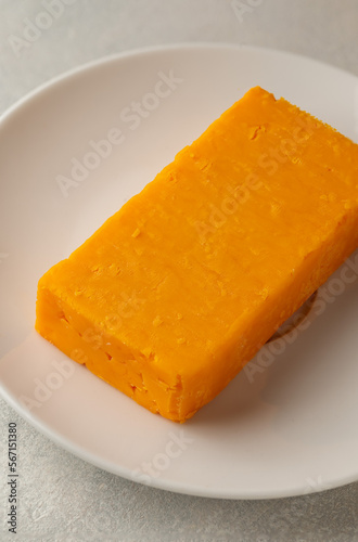 Cheddar orange cheese block, Graysons background, copy space.