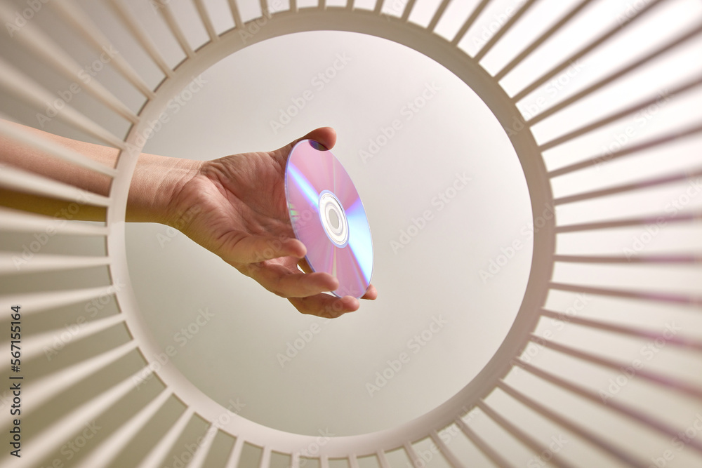 The DVD disc is thrown into the trash for disposal and recycling. View