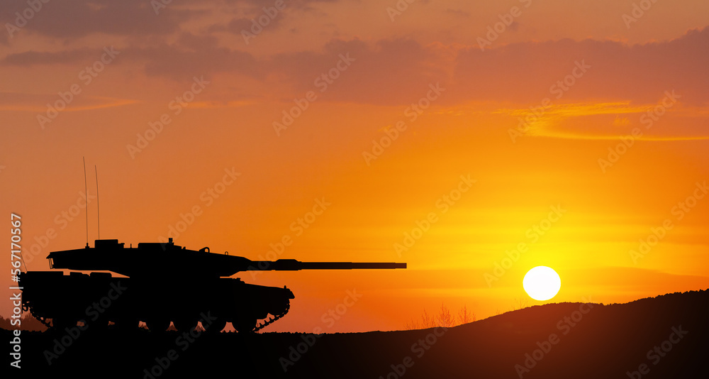 Fototapeta premium Silhouette of army tank at sunset sky background. Military machinery.