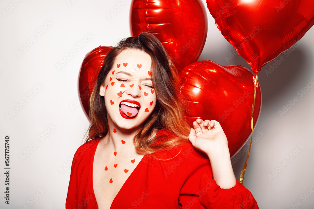 Beautiful woman with heart stickers on her face. Girl on a white