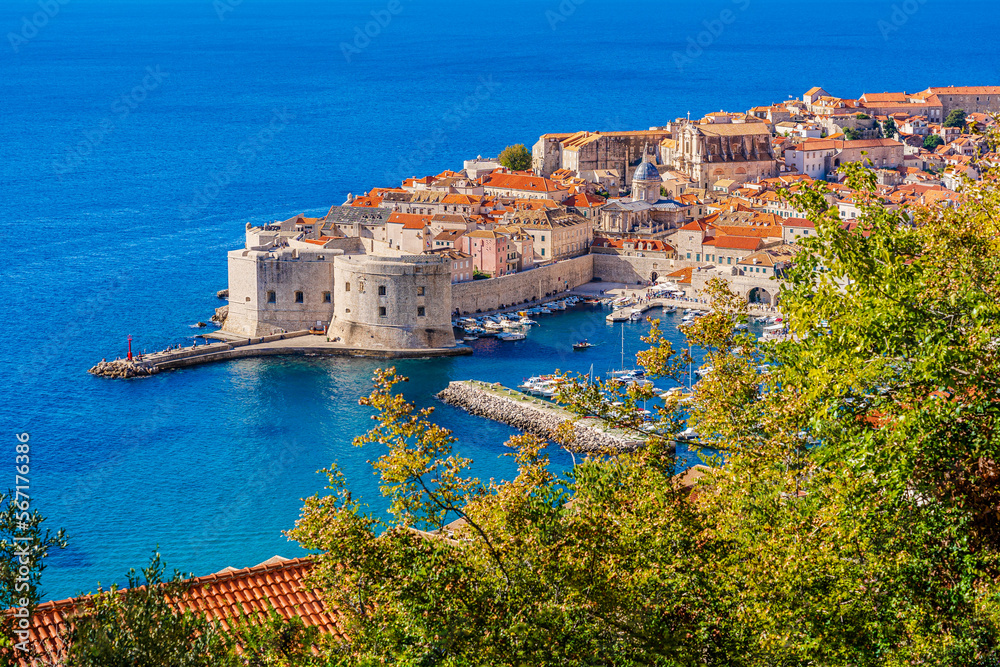Dubrovnik, Croatia: Panoramic view of the old harbor and fortified old town on the shores of the Adriatic Sea; small coastal town on the Croatian Mediterranean riviera