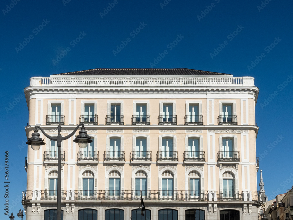 Madrid, Spain. April 6, 2022: architecture and facade of houses with beautiful blue sky.