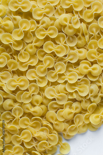 Top view of Farfalle tonde pasta shells on a table, dry uncooked Farfalle tonde