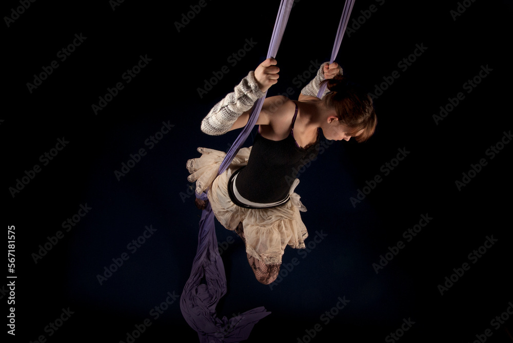 aerial dancer posing in purple fabric aerial dancer posing in purple fabric