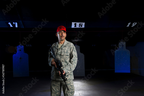 A military police officer stands at the shooting range with his rifle. photo